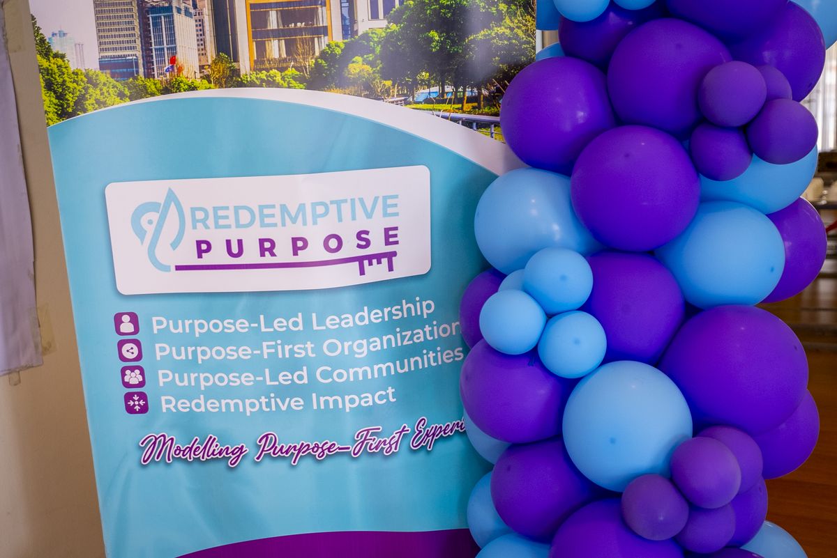 The Redemptive Purpose banner and balloon arch at PurposeFest 2025