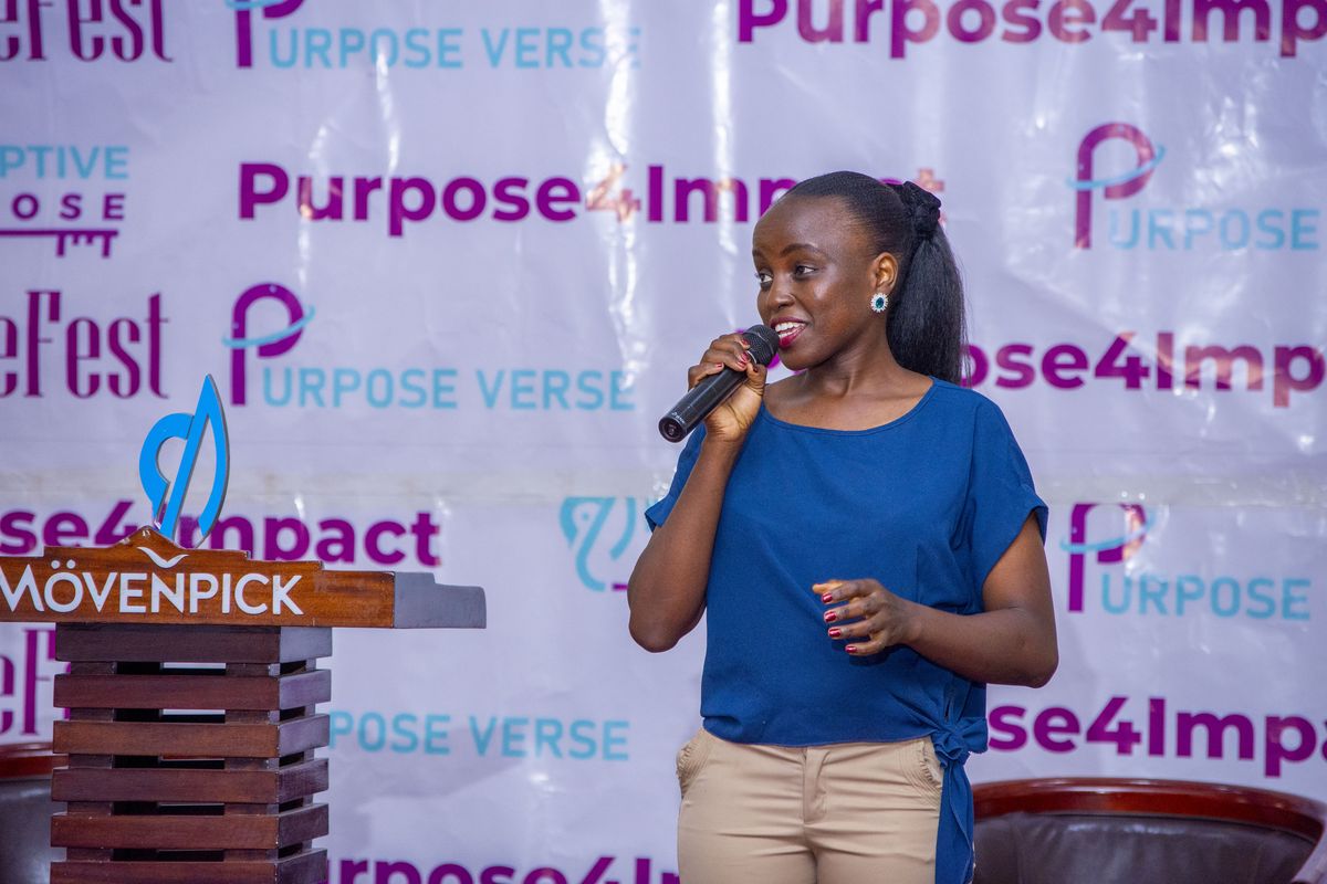 A speaker at the Purpose4Impact backdrop, PurposeFest 2025